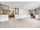 Bright, open living room featuring neutral carpeting and a view into other rooms at 11936 E Oregon Cir, Aurora, CO 80012