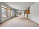 Spacious living room featuring a large window for natural light and neutral carpeting at 11936 E Oregon Cir, Aurora, CO 80012