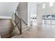 Modern staircase with dark wood railing and carpeted steps at 5723 Farrier Pt, Castle Rock, CO 80104