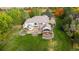 Aerial view of the expansive backyard featuring multiple patios, outdoor seating areas, and a lush lawn at 10667 E Goose Haven Dr, Lafayette, CO 80026