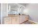 Modern bathroom featuring double vanity, sleek mirrors, pendant lighting, and ample counter space at 10667 E Goose Haven Dr, Lafayette, CO 80026