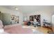 Versatile bedroom space featuring built-in bookshelves, a workspace, hardwood floors, and natural light at 10667 E Goose Haven Dr, Lafayette, CO 80026