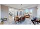 Inviting dining room featuring a large table, elegant chandelier, and beautiful views at 10667 E Goose Haven Dr, Lafayette, CO 80026