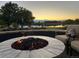 Outdoor space with a fire pit and lounge chairs overlooking a tranquil waterfront setting at 10667 E Goose Haven Dr, Lafayette, CO 80026