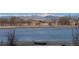 Scenic view of a lake with mountains in the distance, showcasing the property's serene natural surroundings at 10667 E Goose Haven Dr, Lafayette, CO 80026