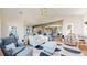 Spacious living room with open layout, neutral tones, and a view of the modern kitchen at 10667 E Goose Haven Dr, Lafayette, CO 80026