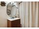 Modern bathroom with sleek vanity, oval mirror, and decorative shower curtain at 4520 Forest Hill Rd, Evergreen, CO 80439