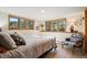 Cozy bedroom with wooded views from the windows and decorative chair at 4520 Forest Hill Rd, Evergreen, CO 80439