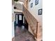 Inviting entryway with wooden staircase, tiled floor, and ample natural light at 4520 Forest Hill Rd, Evergreen, CO 80439