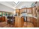 Kitchen with custom wood cabinets, breakfast bar and skylight providing ample natural light at 4520 Forest Hill Rd, Evergreen, CO 80439