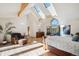 Bright Primary bedroom featuring a vaulted ceiling, skylights, and a wall of view-framing windows at 4520 Forest Hill Rd, Evergreen, CO 80439