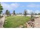 Expansive backyard featuring lush lawn, mature trees, and white fencing at 9650 Raven St, Firestone, CO 80504