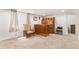 Spacious carpeted basement featuring a bar, furniture, and a window at 9650 Raven St, Firestone, CO 80504