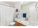 Bathroom featuring a toilet, a sink with marble counter, a shower with patterned shower curtain and nautical decor at 9650 Raven St, Firestone, CO 80504