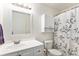 Bathroom featuring a toilet, a sink, a shower with patterned shower curtain and mirror at 9650 Raven St, Firestone, CO 80504