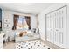 Cozy bedroom featuring a daybed, a window, a sun mirror, and a patterned rug at 9650 Raven St, Firestone, CO 80504