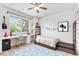 Charming bedroom featuring a large window, a desk, and decor at 9650 Raven St, Firestone, CO 80504