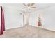Carpeted room with multiple doors and an ensuite bathroom featuring light-colored walls at 9650 Raven St, Firestone, CO 80504