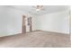 Empty carpeted bedroom with ceiling fan, a window, and light walls at 9650 Raven St, Firestone, CO 80504