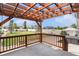 Beautiful deck overlooking a well-maintained backyard, featuring a pergola and hot tub at 9650 Raven St, Firestone, CO 80504