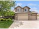 Charming two-story home with a stone-accented facade, three-car garage, and welcoming front porch at 9650 Raven St, Firestone, CO 80504