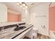 Clean bathroom with a dark marble countertop, integrated sink, retro pink tile accents, and modern fixtures at 1265 Colorado Blvd # 12, Denver, CO 80206