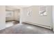 Bright living room with plush carpet, neutral walls, and natural light creates an inviting atmosphere at 1265 Colorado Blvd # 12, Denver, CO 80206