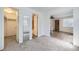 Open living space with wood-look flooring transitioning to carpet, offering a versatile layout and ample storage at 1265 Colorado Blvd # 12, Denver, CO 80206