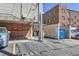 Assigned parking spaces with nearby garages in a brick apartment building at 1265 Colorado Blvd # 12, Denver, CO 80206