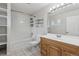 Bathroom features a shower-tub combo, sleek white cabinets, and a wood vanity at 6270 Harlan St, Arvada, CO 80003