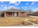 Charming brick home featuring a well-manicured lawn and classic architectural details at 6270 Harlan St, Arvada, CO 80003