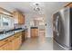 Open kitchen layout with stainless steel appliances and view to living area at 6270 Harlan St, Arvada, CO 80003