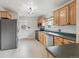 Functional kitchen featuring stainless steel appliances and ample cabinet space at 6270 Harlan St, Arvada, CO 80003
