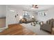Bright living room with hardwood floors, stylish furniture, and plenty of natural light at 6270 Harlan St, Arvada, CO 80003