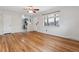 Inviting open floorplan with hardwood floors connecting to the kitchen area at 6270 Harlan St, Arvada, CO 80003