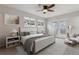 This main bedroom has two large windows, stylish decor, and a door to the back yard at 6270 Harlan St, Arvada, CO 80003
