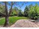 Lush backyard showcases mature trees, green lawn, and stone patio perfect for enjoying the outdoors at 3145 W 31St Ave, Denver, CO 80211