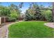 Lush backyard featuring manicured lawn, mature trees, and walking path at 3145 W 31St Ave, Denver, CO 80211