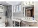 Bright bathroom featuring pedestal sink, updated fixtures, and stylish vanity at 3145 W 31St Ave, Denver, CO 80211