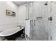 Charming bathroom featuring subway tiles, a clawfoot tub, and a glass-enclosed shower with a built-in bench at 3145 W 31St Ave, Denver, CO 80211