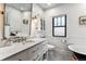 Elegant bathroom with marble countertops, a vintage style faucet, and modern fixtures and finishes at 3145 W 31St Ave, Denver, CO 80211