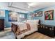 Cozy bedroom with blue walls, unique artwork, and comfortable furnishings for a peaceful retreat at 3145 W 31St Ave, Denver, CO 80211