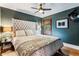 Cozy bedroom with a tufted headboard, dark green walls, and natural light from a window with wooden blinds at 3145 W 31St Ave, Denver, CO 80211