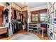 Well-organized walk-in closet with ample storage, custom shelving, and natural light from a window at 3145 W 31St Ave, Denver, CO 80211