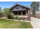 Inviting home featuring a front porch, well-manicured lawn, and brick accents at 3145 W 31St Ave, Denver, CO 80211