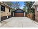 A well-maintained detached garage with a concrete driveway enhances the home's curb appeal at 3145 W 31St Ave, Denver, CO 80211