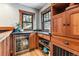 Charming bar area with a mini fridge, granite countertop, and custom wood cabinetry for added storage at 3145 W 31St Ave, Denver, CO 80211