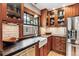 Charming kitchen with wood cabinets, a farmhouse sink, stainless steel appliances and a view from the window at 3145 W 31St Ave, Denver, CO 80211