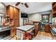 Spacious kitchen featuring wood cabinets, stainless steel appliances, a marble-top island, and a cozy breakfast nook at 3145 W 31St Ave, Denver, CO 80211