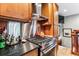 Modern kitchen featuring stainless steel appliances, granite countertops, and custom wood cabinetry at 3145 W 31St Ave, Denver, CO 80211